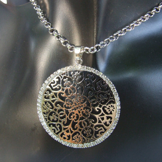 Long necklace with openwork round pendant with silver tone rhinestones