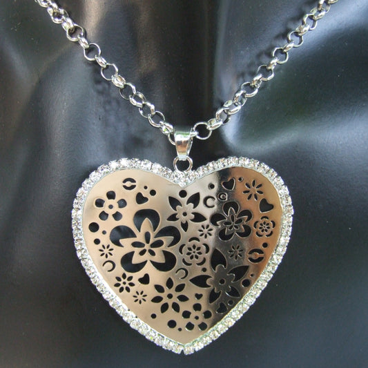 Long openwork heart pendant necklace with silver tone rhinestones