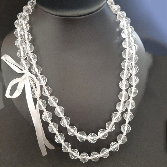 Long faceted transparent pearl necklace with bow