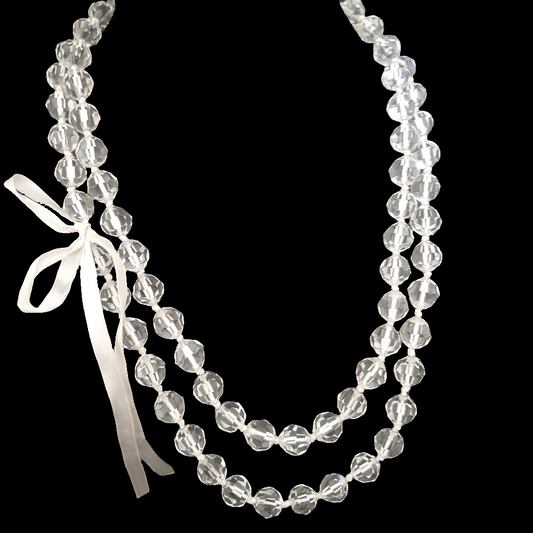 Long faceted transparent pearl necklace with bow