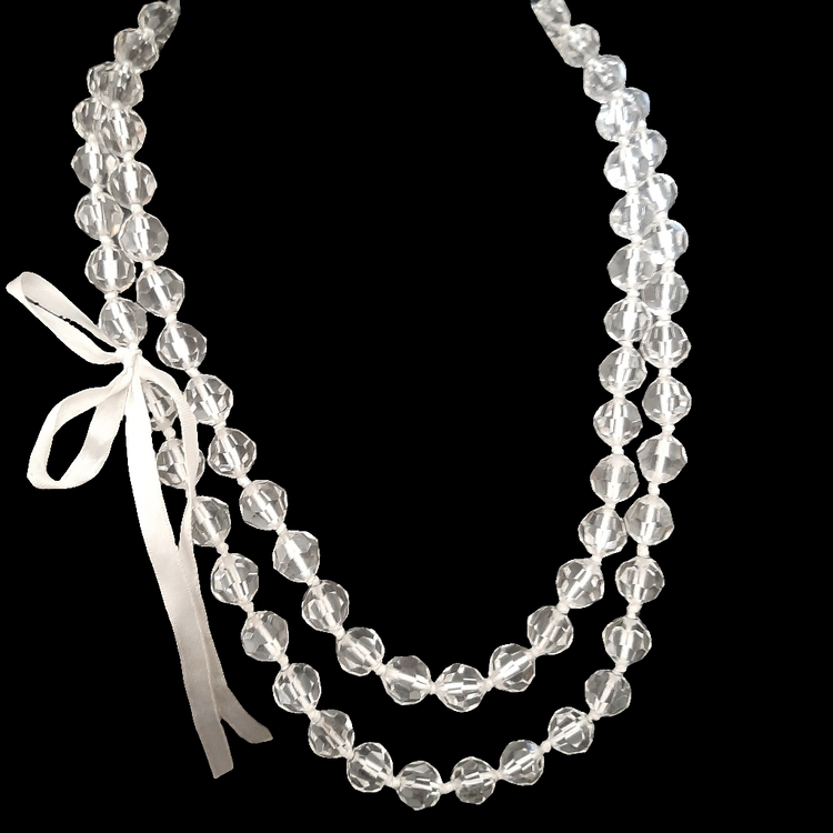 Long faceted transparent pearl necklace with bow