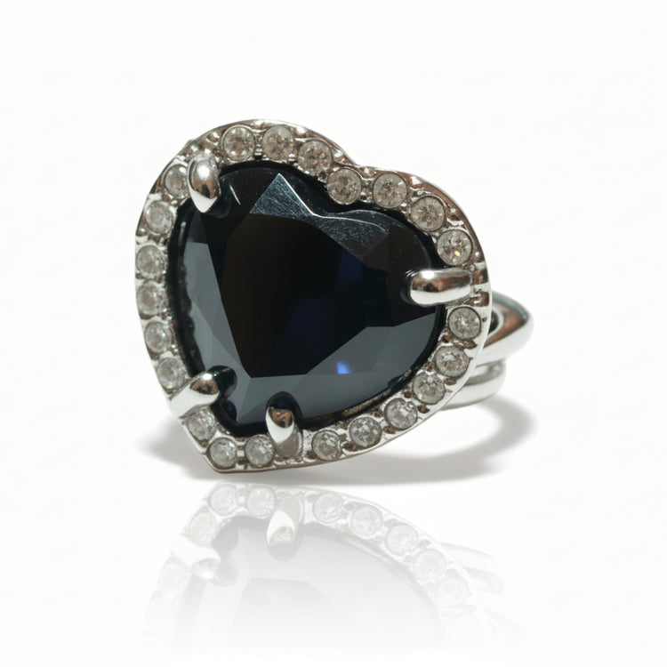 Large women's silver tone ring with purple tone stones