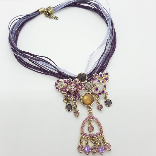 Necklace with central purple and gold stones and rhinestones